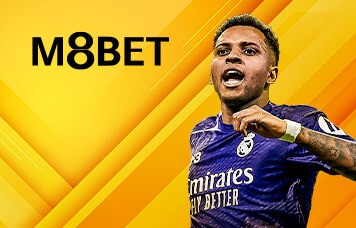 M8BET sportsbook on MWIN8 featuring Real Madrid attacker Rodrygo celebrating in purple jersey with yellow background.